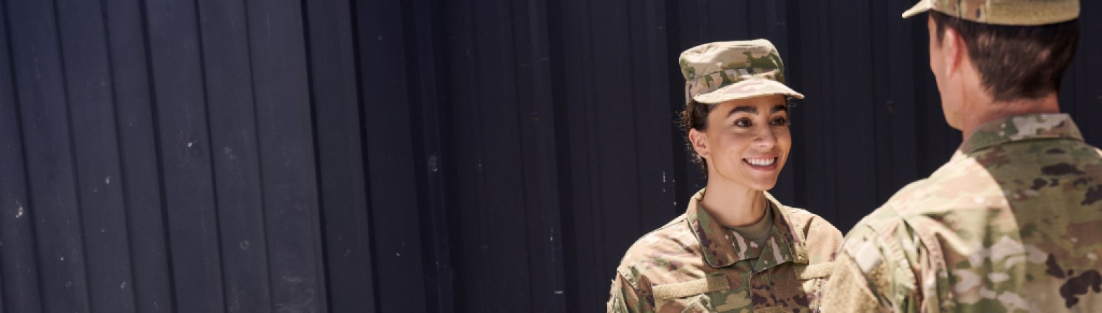 two military servicemembers talk to each other